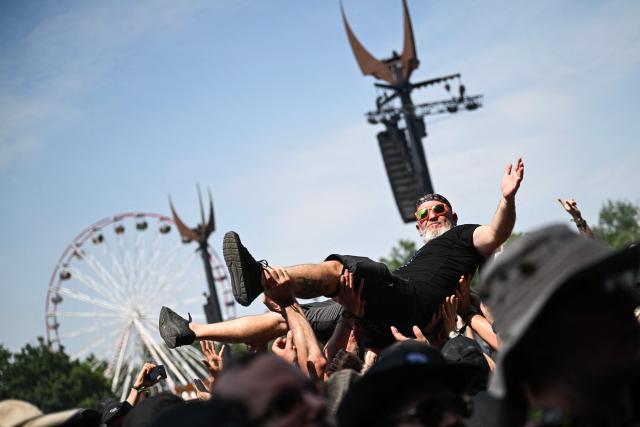 A festival goer takes part in the 19th edition of Hellfest rock and heavy metal festival, in Clisson, western France, on June 19, 2026. (Photo by Sebastien Salom-Gomis / AFP)