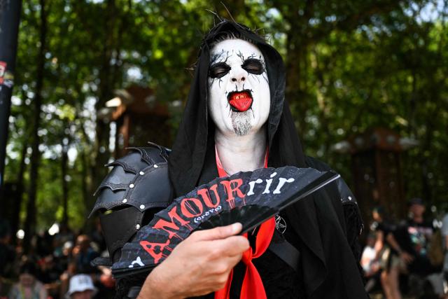 A festival goer poses during the 19th edition of Hellfest rock and heavy metal festival, in Clisson, western France, on June 19, 2026. (Photo by Sebastien Salom-Gomis / AFP)