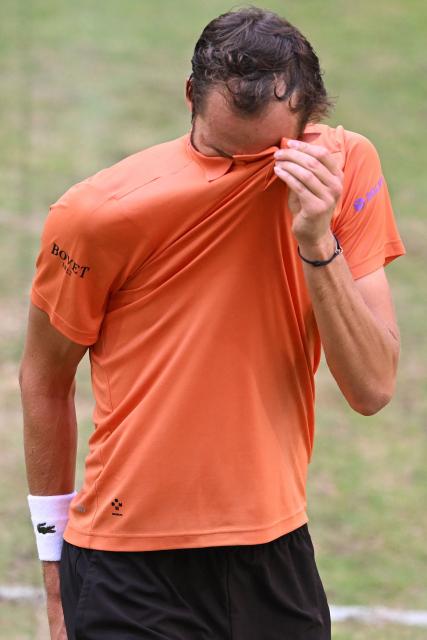 Russia's Daniil Medvedev reacts while playing against Germany's Daniel Altmaier during their men's singles quarter-final match of the Halle Open ATP tennis tournament in Halle, western Germany, on June 19, 2026. (Photo by CARMEN JASPERSEN / AFP)