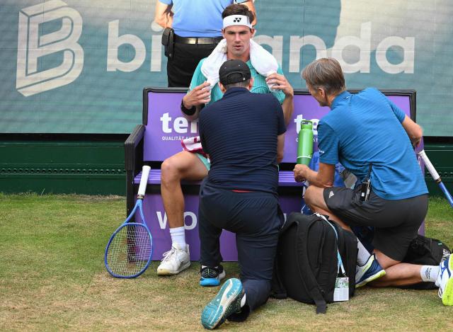 Germany's Daniel Altmaier receives medical attention while playing against Russia's Daniil Medvedev during their men's singles quarter-final match of the Halle Open ATP tennis tournament in Halle, western Germany, on June 19, 2026. (Photo by CARMEN JASPERSEN / AFP)