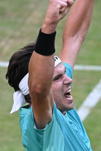Germany's Daniel Altmaier celebrates after winning against Russia's Daniil Medvedev during their men's singles quarter-final match of the Halle Open ATP tennis tournament in Halle, western Germany, on June 19, 2026. (Photo by CARMEN JASPERSEN / AFP)