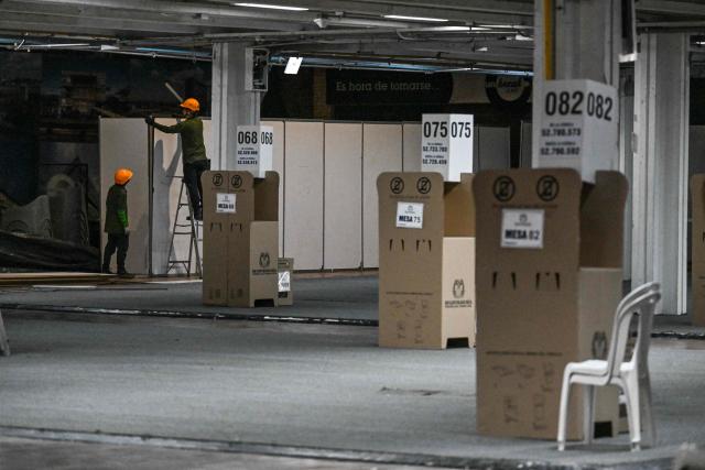 Workers fix a hall of the Corferias polling center in Bogota,on June 19, 2026, ahead of the presidential runoff election. Colombians vote on June 21, 2026 in a presidential runoff pitting a hard-right opera-singer-turned-lawyer against a leftist senator, an election with stark consequences for the country's stumbling peace process with armed groups and strained ties with Washington. (Photo by Juan BARRETO / AFP)