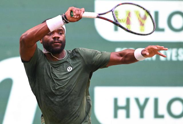 USA's Frances Tiafoe returns the ball to Canada's Felix Auger-Aliassime during their men's singles quarter-final match of the Halle Open ATP tennis tournament in Halle, western Germany, on June 19, 2026. (Photo by CARMEN JASPERSEN / AFP)