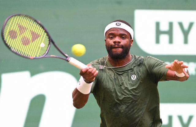 USA's Frances Tiafoe returns the ball to Canada's Felix Auger-Aliassime during their men's singles quarter-final match of the Halle Open ATP tennis tournament in Halle, western Germany, on June 19, 2026. (Photo by CARMEN JASPERSEN / AFP)
