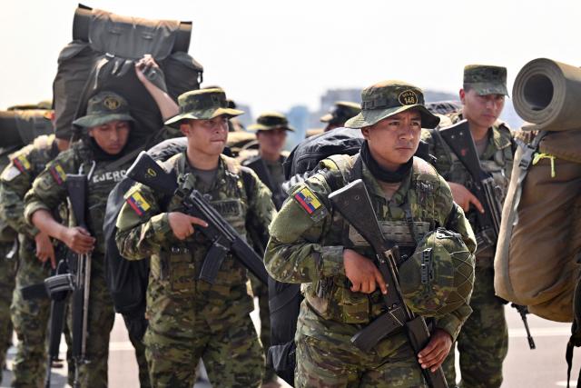 Indigenous soldiers from Ecuador's elite IWIAS unit arrive at Simon Bolivar Air Base in Guayaquil, Ecuador, on June 19, 2026, amid a state of emergency declared in 10 provinces. Ecuador's President Daniel Noboa declared a new state of emergency on June 17, 2026, in 10 of the country's 24 provinces amid a surge in violence by drug trafficking groups. (Photo by MARCOS PIN / AFP)