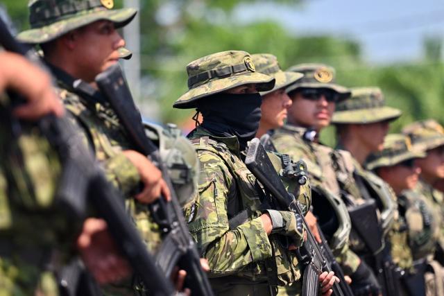 Indigenous soldiers from Ecuador's elite IWIAS unit arrive at Simon Bolivar Air Base in Guayaquil, Ecuador, on June 19, 2026, amid a state of emergency declared in 10 provinces. Ecuador's President Daniel Noboa declared a new state of emergency on June 17, 2026, in 10 of the country's 24 provinces amid a surge in violence by drug trafficking groups. (Photo by MARCOS PIN / AFP)