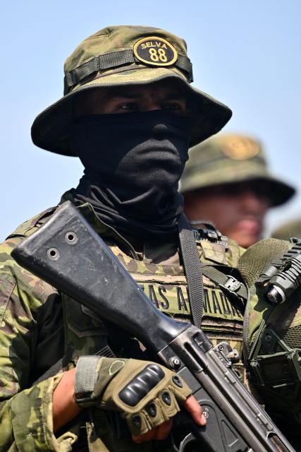 Indigenous soldiers from Ecuador's elite IWIAS unit arrive at Simon Bolivar Air Base in Guayaquil, Ecuador, on June 19, 2026, amid a state of emergency declared in 10 provinces. Ecuador's President Daniel Noboa declared a new state of emergency on June 17, 2026, in 10 of the country's 24 provinces amid a surge in violence by drug trafficking groups. (Photo by MARCOS PIN / AFP)