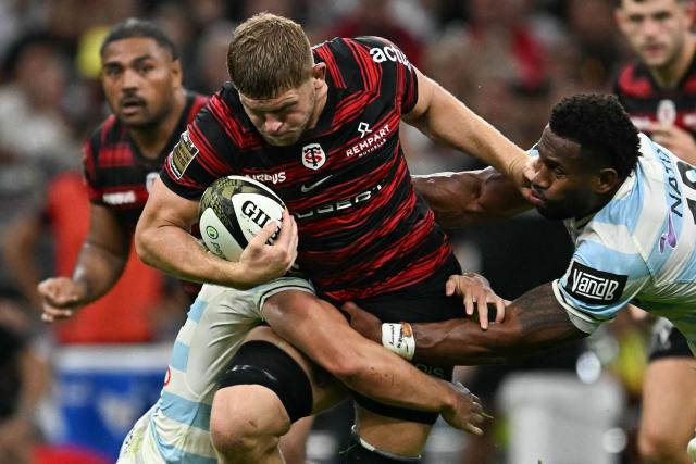 Toulouse's English flanker Jack Willis is tackled during the French Top14 rugby union semi-final match between Stade Toulousain Rugby (Toulouse) and Racing 92 at the Velodrome stadium in Marseille, southern France on June 19, 2026. (Photo by Gabriel BOUYS / AFP)