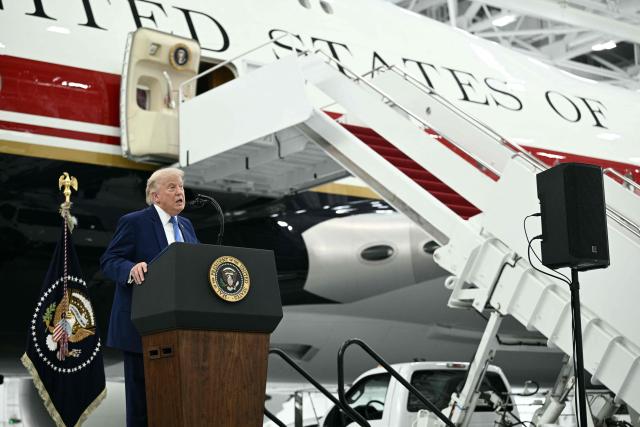 US President Donald Trump speaks in front of the new Air Force One, gifted to him by by Qatar, in a hangar at Joint Base Andrews in Maryland on June 19, 2026. White House officials bade farewell on June 18, 2026 to one of the two jets that have been used to transport US presidents for more than 30 years. The goodbye messages fueled speculation that a Boeing 747 controversially gifted to President Donald Trump by the Gulf emirate of Qatar is now due to enter service. Trump will be heading to Joint Base Andrews before spending the weekend at Camp David. (Photo by Brendan SMIALOWSKI / AFP)