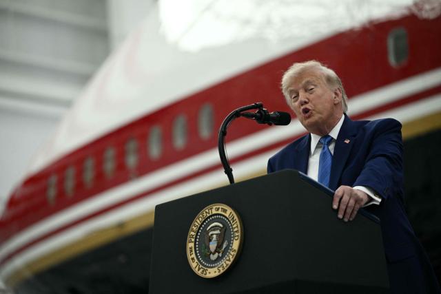 US President Donald Trump speaks in front of the new Air Force One, gifted to him by by Qatar, in a hangar at Joint Base Andrews in Maryland on June 19, 2026. White House officials bade farewell on June 18, 2026 to one of the two jets that have been used to transport US presidents for more than 30 years. The goodbye messages fueled speculation that a Boeing 747 controversially gifted to President Donald Trump by the Gulf emirate of Qatar is now due to enter service. Trump will be heading to Joint Base Andrews before spending the weekend at Camp David. (Photo by Brendan SMIALOWSKI / AFP)