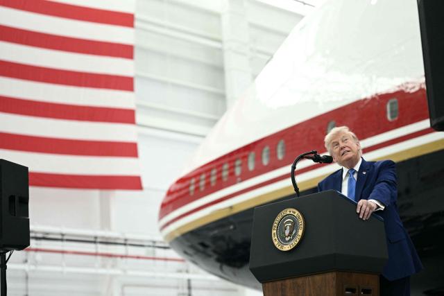 US President Donald Trump speaks in front of the new Air Force One, gifted to him by by Qatar, in a hangar at Joint Base Andrews in Maryland on June 19, 2026. White House officials bade farewell on June 18, 2026 to one of the two jets that have been used to transport US presidents for more than 30 years. The goodbye messages fueled speculation that a Boeing 747 controversially gifted to President Donald Trump by the Gulf emirate of Qatar is now due to enter service. Trump will be heading to Joint Base Andrews before spending the weekend at Camp David. (Photo by Brendan SMIALOWSKI / AFP)