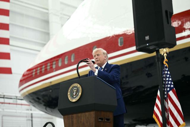 US President Donald Trump speaks in front of the new Air Force One, gifted to him by by Qatar, in a hangar at Joint Base Andrews in Maryland on June 19, 2026. White House officials bade farewell on June 18, 2026 to one of the two jets that have been used to transport US presidents for more than 30 years. The goodbye messages fueled speculation that a Boeing 747 controversially gifted to President Donald Trump by the Gulf emirate of Qatar is now due to enter service. Trump will be heading to Joint Base Andrews before spending the weekend at Camp David. (Photo by Brendan SMIALOWSKI / AFP)
