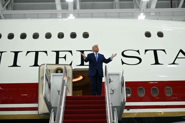 US President Donald Trump steps out of the new Air Force One, gifted to him by Qatar, in a hangar at Joint Base Andrews in Maryland on June 19, 2026. White House officials bade farewell on June 18, 2026 to one of the two jets that have been used to transport US presidents for more than 30 years. The goodbye messages fueled speculation that a Boeing 747 controversially gifted to President Donald Trump by the Gulf emirate of Qatar is now due to enter service. Trump will be heading to Joint Base Andrews before spending the weekend at Camp David. (Photo by Brendan SMIALOWSKI / AFP)