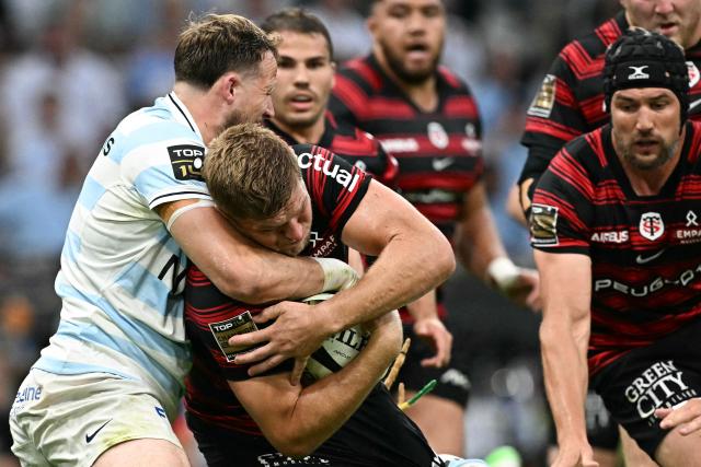 Toulouse's English flanker Jack Willis is tackled during the French Top14 rugby union semi-final match between Stade Toulousain Rugby (Toulouse) and Racing 92 at the Velodrome stadium in Marseille, southern France on June 19, 2026. (Photo by Gabriel BOUYS / AFP)