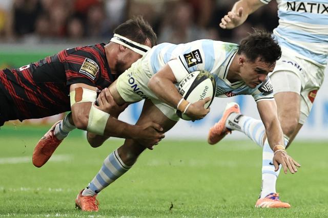Racing 92' French full-back Max Spring is tackled during the French Top14 rugby union semi-final match between Stade Toulousain Rugby (Toulouse) and Racing 92 at the Velodrome stadium in Marseille, southern France on June 19, 2026. (Photo by Thibaud MORITZ / AFP)