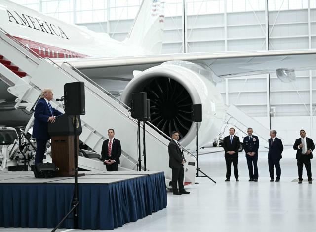 US President Donald Trump speaks in front of the new Air Force One, gifted to him by Qatar, in a hangar at Joint Base Andrews in Maryland on June 19, 2026. White House officials bade farewell on June 18, 2026 to one of the two jets that have been used to transport US presidents for more than 30 years. The goodbye messages fueled speculation that a Boeing 747 controversially gifted to President Donald Trump by the Gulf emirate of Qatar is now due to enter service. Trump will be heading to Joint Base Andrews before spending the weekend at Camp David. (Photo by Brendan SMIALOWSKI / AFP)