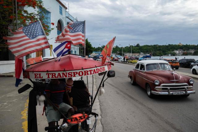 A tricycle is decorated with US and Cuban flags in Havana on June 19, 2026. (Photo by YAMIL LAGE / AFP)