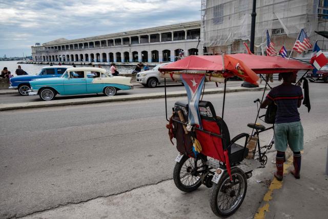 A tricycle is decorated with US and Cuban flags in Havana on June 19, 2026. (Photo by YAMIL LAGE / AFP)