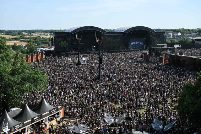 Heavy metal fans enjoy a show during the 19th edition of Hellfest rock and heavy metal festival, in Clisson, western France, on June 19, 2026. (Photo by Sebastien Salom-Gomis / AFP)