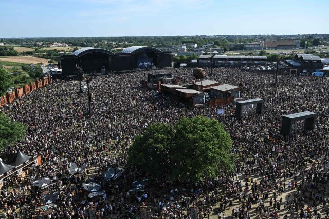 Heavy metal fans enjoy a show during the 19th edition of Hellfest rock and heavy metal festival, in Clisson, western France, on June 19, 2026. (Photo by Sebastien Salom-Gomis / AFP)