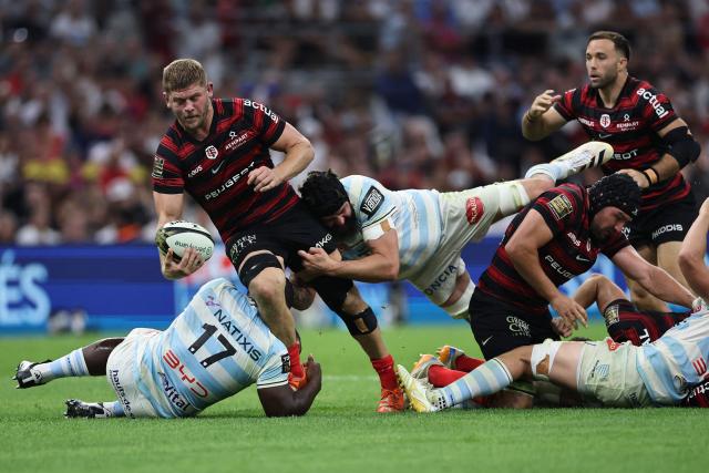 Toulouse's English flanker Jack Willis is tackled during the French Top14 rugby union semi-final match between Stade Toulousain Rugby (Toulouse) and Racing 92 at the Velodrome stadium in Marseille, southern France on June 19, 2026. (Photo by Thibaud MORITZ / AFP)