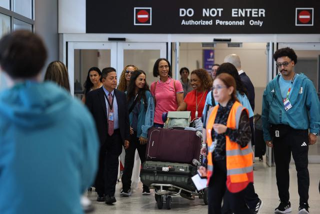 Ana Candida Evora (C), the mother Cape Verde's goalkeeper Vozinha, exits a terminal upon arrival at Miami International Airport on June 19, 2026, during the 2026 World Cup football tournament. Vozinha's mother, who was unable to enter the United States over visa price issues, arrived to the country to attend the upcoming matches of Cape Verde. (Photo by PATRICIA DE MELO MOREIRA / AFP)