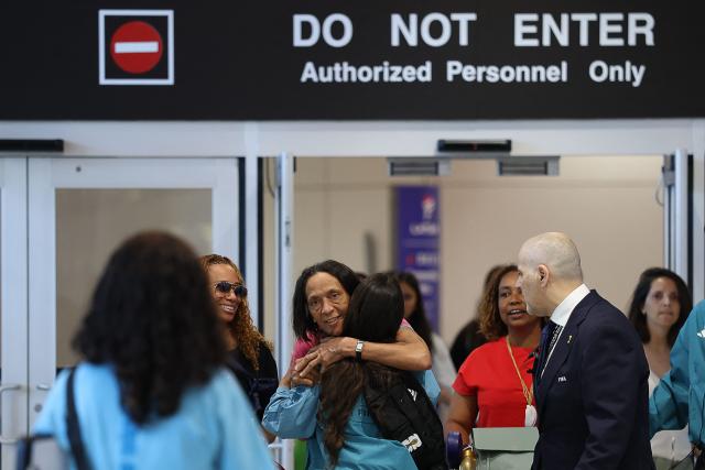 Ana Candida Evora (C), the mother Cape Verde's goalkeeper Vozinha, reacts upon arrival at Miami International Airport on June 19, 2026, during the 2026 World Cup football tournament. Vozinha's mother, who was unable to enter the United States over visa price issues, arrived to the country to attend the upcoming matches of Cape Verde. (Photo by PATRICIA DE MELO MOREIRA / AFP)