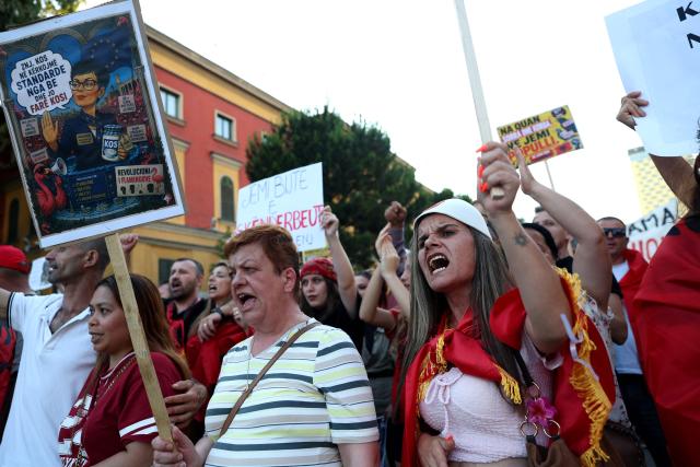 Protestors hold placards as they gather in front of Albania's Prime Minister's Office during a demonstration against a luxury resort development near a protected natural area, in Tirana, on June 19, 2026. Several thousand citizens demonstrated in Tirana for the twentieth consecutive day, to demand transparency around a tourist complex project allegedly linked to US President's daugther Ivanka and her husband Jared Kushner. The demonstrators argue that the estimated $1.2 billion project will harm the environment, with plans for luxury hotels in the protected area of Vjosa-Narta on the southern coast. (Photo by Adnan Beci / AFP)