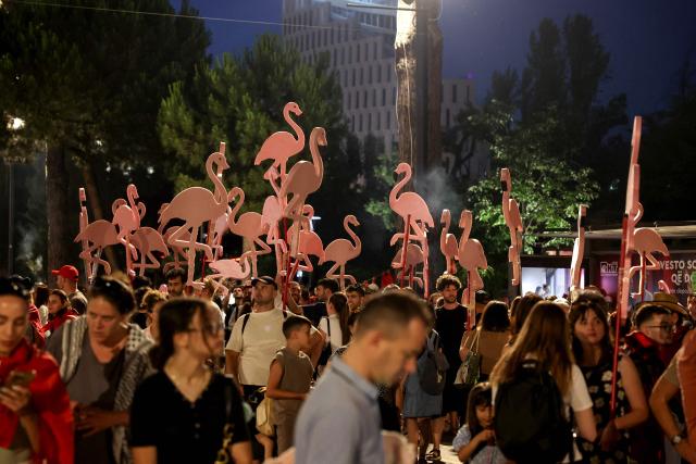 Protestors hold cardboard cutouts of flamingos as they gather in front of Albania's Prime Minister's Office during a demonstration against a luxury resort development near a protected natural area, in Tirana on June 19, 2026. Several thousand citizens demonstrated in Tirana for the twentieth consecutive day, to demand transparency around a tourist complex project allegedly linked to US President's daugther Ivanka and her husband Jared Kushner. The demonstrators argue that the estimated $1.2 billion project will harm the environment, with plans for luxury hotels in the protected area of Vjosa-Narta on the southern coast. (Photo by Adnan Beci / AFP)