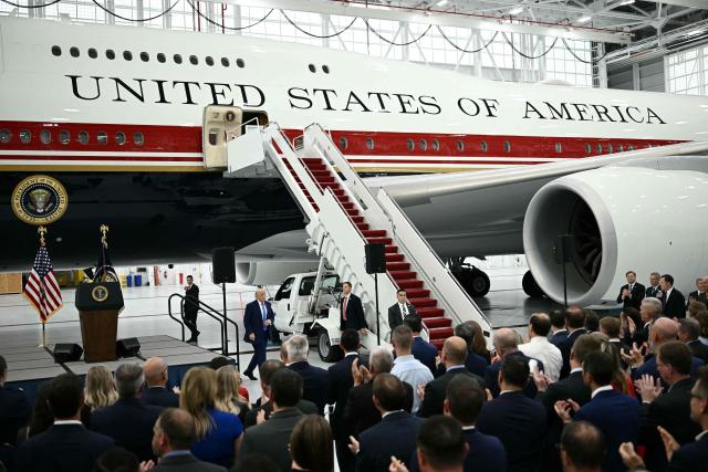 US President Donald Trump walks past the new Air Force One, gifted to him by Qatar, in a hangar at Joint Base Andrews in Maryland on June 19, 2026. White House officials bade farewell on June 18, 2026 to one of the two jets that have been used to transport US presidents for more than 30 years. The goodbye messages fueled speculation that a Boeing 747 controversially gifted to President Donald Trump by the Gulf emirate of Qatar is now due to enter service. Trump will be heading to Joint Base Andrews before spending the weekend at Camp David. (Photo by Brendan SMIALOWSKI / AFP)