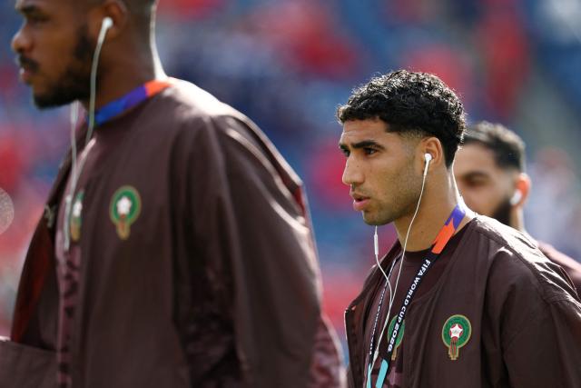 Morocco's defender #02 Achraf Hakimi uses earbuds as he walks on the pitch ahead of the 2026 World Cup Group C football match between Scotland and Morocco at the Boston Stadium in Foxborough on June 19, 2026.  (Photo by FRANCK FIFE / AFP)