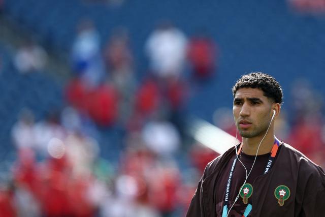 Morocco's defender #02 Achraf Hakimi uses earbuds as he walks on the pitch ahead of the 2026 World Cup Group C football match between Scotland and Morocco at the Boston Stadium in Foxborough on June 19, 2026.  (Photo by FRANCK FIFE / AFP)