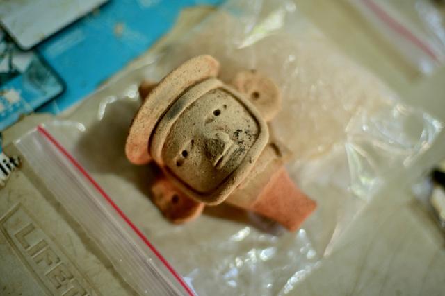 A view shows an anthropomorphic whistle face handled by archaeologists working at an archaeological site in Coatepec, Veracruz, Mexico, on June 18, 2026. Mexican archaeologists have discovered the remains of a structure and a sculpture bearing features similar to those of the Maya culture and other characteristics described as “never before seen” in the eastern state of Veracruz. (Photo by Marco Antonio MARTINEZ / AFP)
