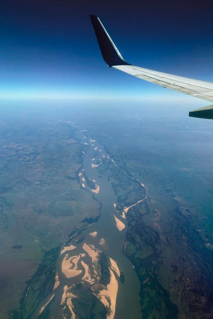 (FILES) Aerial view of the Parana river between Itati and Yahape in Corrientes province, Argentina (L) and Nembuccu department Paraguay on June 12, 2024. The Argentine government confirmed on June 19, 2026 that the consortium comprising the Belgian company Jan De Nul and the local firm Servimagnus will hold a 25-year concession for the dredging and marking of the Parana-Paraguay waterway, through which 80 per cent of the country's exports are transported. (Photo by JUAN MABROMATA / AFP)