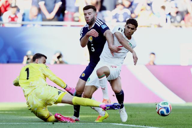 Morocco's defender #02 Achraf Hakimi, Scotland's defender #05 Grant Hanley and goalkeeper #01 Angus Gunn fight for the ball during the 2026 World Cup Group C football match between Scotland and Morocco at the Boston Stadium in Foxborough on June 19, 2026.  (Photo by FRANCK FIFE / AFP)