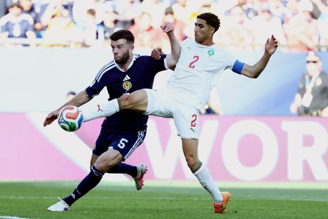 Morocco's defender #02 Achraf Hakimi and Scotland's defender #05 Grant Hanley fight for the ball during the 2026 World Cup Group C football match between Scotland and Morocco at the Boston Stadium in Foxborough on June 19, 2026.  (Photo by FRANCK FIFE / AFP)