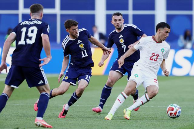 Scotland's forward #11 Ryan Christie, Scotland's midfielder #07 John McGinn and Morocco's midfielder #23 Bilal El Khannouss fight for the ball during the 2026 World Cup Group C football match between Scotland and Morocco at the Boston Stadium in Foxborough on June 19, 2026.  (Photo by FRANCK FIFE / AFP)