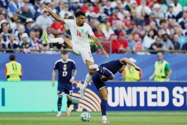 Morocco's defender #18 Chadi Riad and Scotland's forward #10 Che Adams fight for the ball during the 2026 World Cup Group C football match between Scotland and Morocco at the Boston Stadium in Foxborough on June 19, 2026.  (Photo by FRANCK FIFE / AFP)
