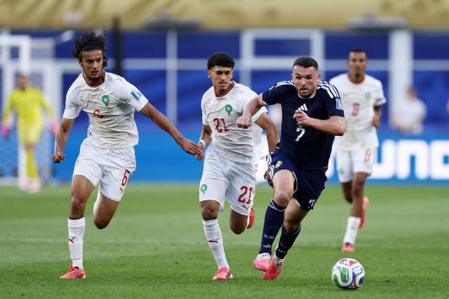 Scotland's midfielder #07 John McGinn, Morocco's midfielder #06 Ayyoub Bouaddi and forward #21 Ayoube Amaimouni fight for the ball during the 2026 World Cup Group C football match between Scotland and Morocco at the Boston Stadium in Foxborough on June 19, 2026.  (Photo by FRANCK FIFE / AFP)