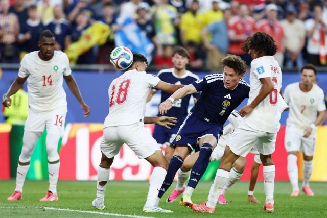 Scotland's midfielder #04 Scott McTominay shoots past Morocco's defender #18 Chadi Riad and midfielder #06 Ayyoub Bouaddi during the 2026 World Cup Group C football match between Scotland and Morocco at the Boston Stadium in Foxborough on June 19, 2026.  (Photo by FRANCK FIFE / AFP)