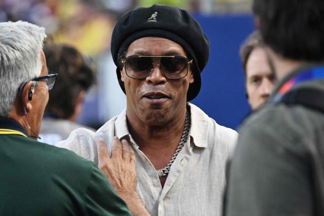 Brazilian former football star Ronaldinho gestures ahead of the 2026 World Cup Group C football match between Brazil and Haiti at the Philadelphia Stadium in Philadelphia on June 19, 2026.  (Photo by Mauro PIMENTEL / AFP)