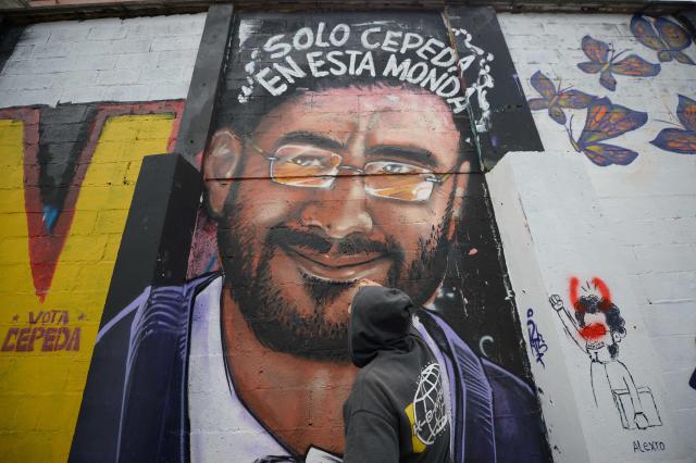 An artist paints a mural depicting Colombia's presidential candidate Ivan Cepeda on a wall in Bogota on June 19, 2026. Colombians vote on June 21, 2026 in a presidential runoff pitting a hard-right opera-singer-turned-lawyer against a leftist senator, an election with stark consequences for the country's stumbling peace process with armed groups and strained ties with Washington. (Photo by Sebastian BARROS / AFP)