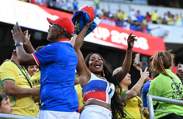 A Haitian fan cheers for her team ahead of the 2026 World Cup Group C football match between Brazil and Haiti at the Philadelphia Stadium in Philadelphia on June 19, 2026.  (Photo by Jewel SAMAD / AFP)
