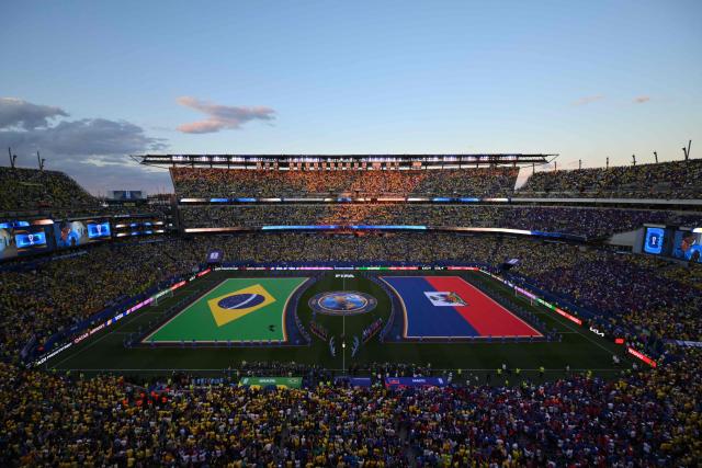 Brazilian and Haitian flags are displayed on the pitch ahead of the 2026 World Cup Group C football match between Brazil and Haiti at the Philadelphia Stadium in Philadelphia on June 19, 2026.  (Photo by ANGELA WEISS / AFP)