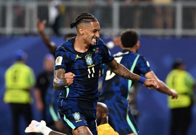 Brazil's forward #11 Raphinha celebrates his team's first goal scored by forward #09 Matheus Cunha (in the background) during the 2026 World Cup Group C football match between Brazil and Haiti at the Philadelphia Stadium in Philadelphia on June 19, 2026.  (Photo by ROBERTO SCHMIDT / AFP)