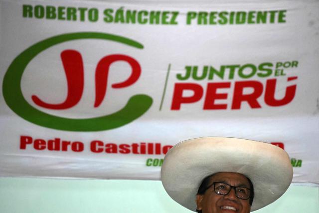 Peru's presidential candidate for the Juntos por el Peru party Roberto Sanchez smiles from the balcony of campaign headquarters after a protest march in Lima on June 19, 2026. Peru's leftist presidential candidate for the Juntos por el Peru party, Roberto Sanchez, led a march of hundreds of supporters in Lima on June 19, to demand transparency in the second-round vote count as he trailed narrowly behind right-wing candidate Keiko Fujimori. (Photo by ERNESTO BENAVIDES / AFP)