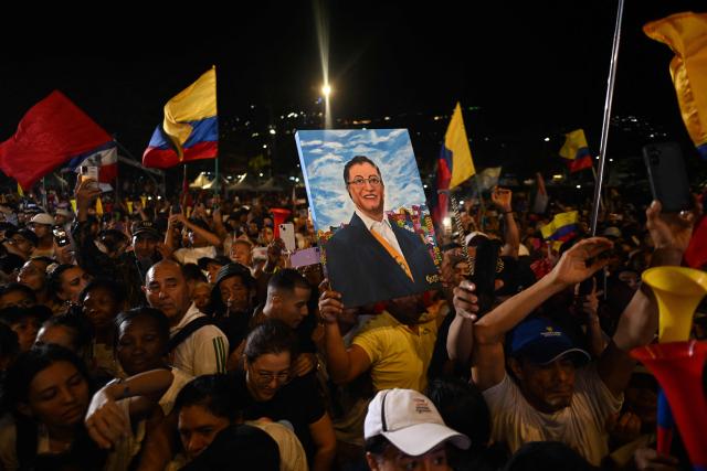 A supporter of Colombia's President Gustavo Petro holds a portrait depicting him during a rally in Cali, Colombia, on June 19, 2026, two days ahead of the presidential runoff. Colombians vote on June 21, 2026 in a presidential runoff pitting a hard-right opera-singer-turned-lawyer against a leftist senator, an election with stark consequences for the country's stumbling peace process with armed groups and strained ties with Washington. (Photo by Joaquin SARMIENTO / AFP)