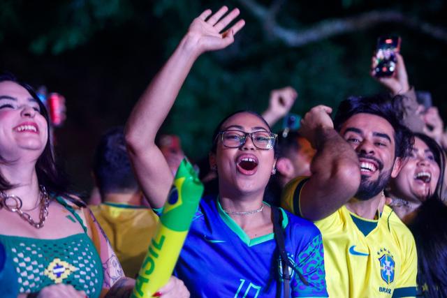 Brazil fans cheer during the FIFA World Cup football match between Brazil and Haiti at Arena Brasileira in Ibirapuera Park, Sao Paulo, Brazil, on June 19, 2026. (Photo by Miguel SCHINCARIOL / AFP)