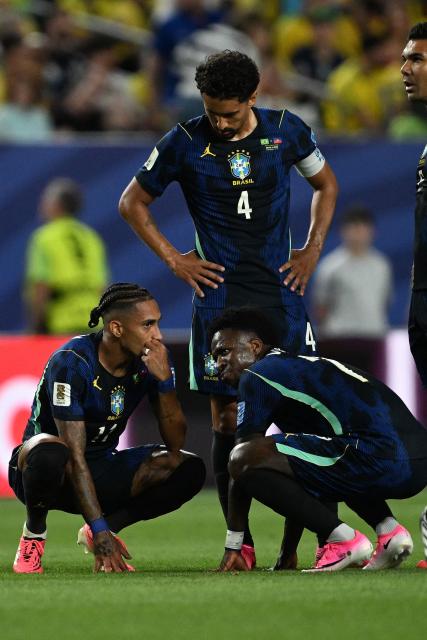 Brazil's forward #11 Raphinha and forward #07 Vinicius Junior speak during the 2026 World Cup Group C football match between Brazil and Haiti at the Philadelphia Stadium in Philadelphia on June 19, 2026.  (Photo by Mauro PIMENTEL / AFP)
