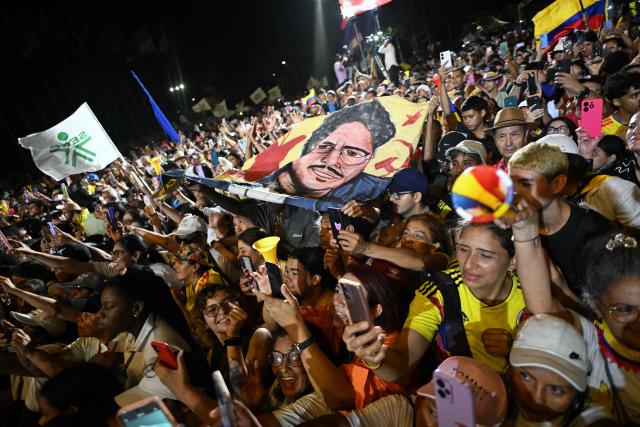 Supporters of Colombia's President Gustavo Petro display a banner featuring presidential candidate Ivan Cepeda of the Pacto Historico party during a rally in Cali, Colombia, on June 19, 2026, two days ahead of the presidential runoff. Colombians vote on June 21, 2026 in a presidential runoff pitting a hard-right opera-singer-turned-lawyer against a leftist senator, an election with stark consequences for the country's stumbling peace process with armed groups and strained ties with Washington. (Photo by Joaquin SARMIENTO / AFP)